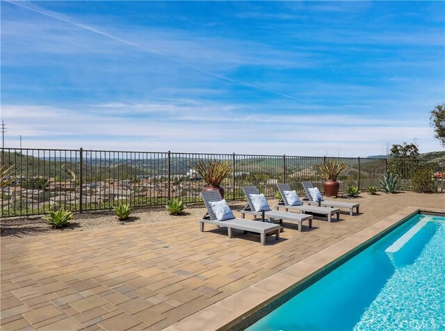 view of swimming pool with a fenced in pool, a fenced backyard, and a patio area