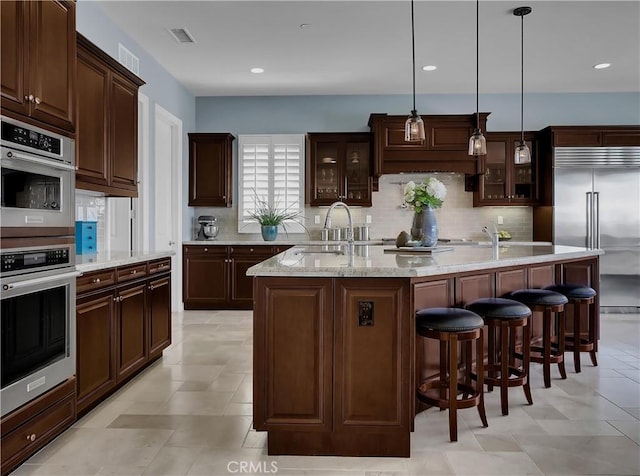 kitchen with stainless steel appliances, visible vents, a wealth of natural light, and a sink