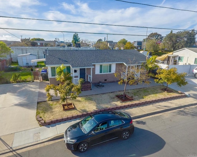 single story home featuring fence and roof with shingles