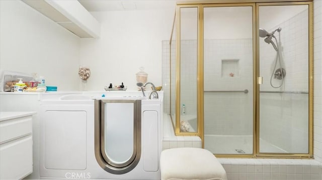 full bathroom with vanity, a tub, and tiled shower