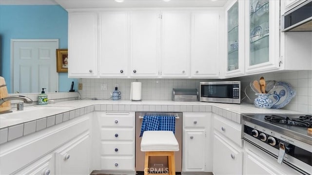 kitchen with white cabinets, appliances with stainless steel finishes, and a sink