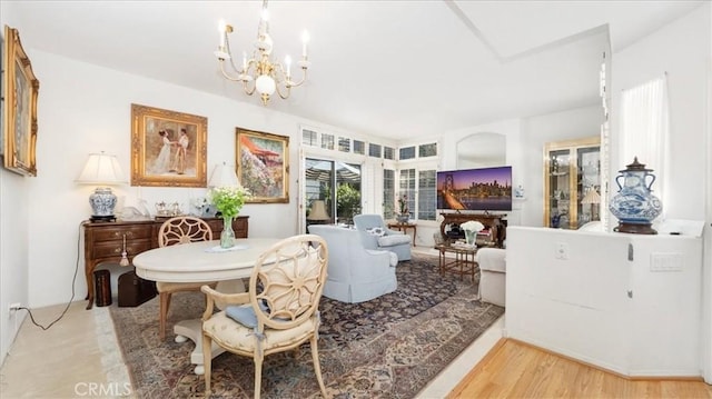 dining space featuring an inviting chandelier and wood finished floors