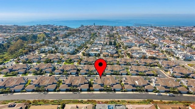 drone / aerial view featuring a residential view and a water view