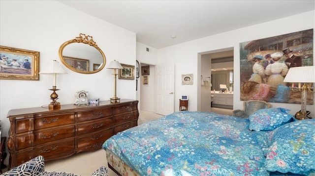 bedroom featuring ensuite bath and carpet floors