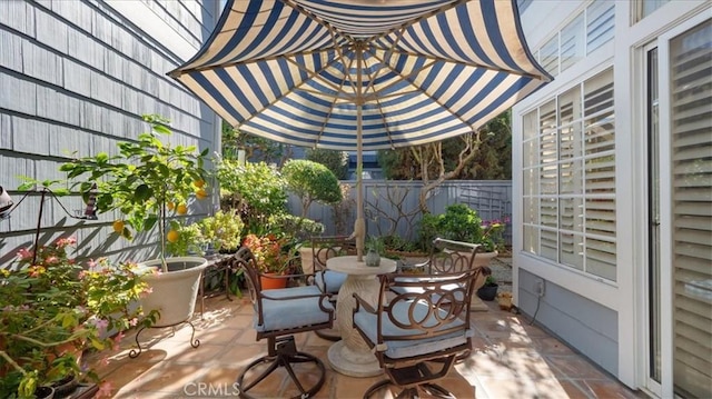 view of patio / terrace with outdoor dining area and fence