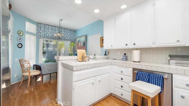 kitchen featuring white cabinetry and a peninsula