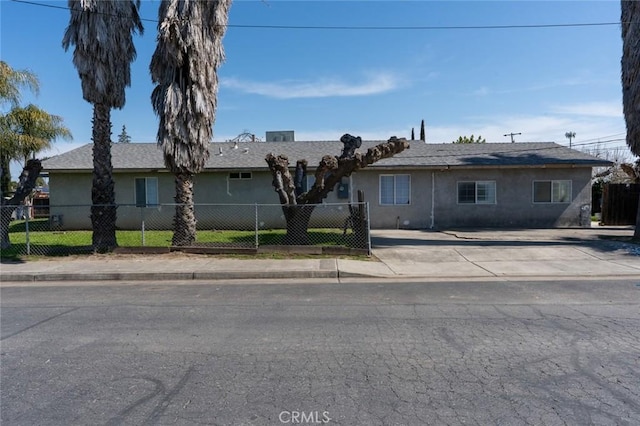 single story home with a fenced front yard and stucco siding