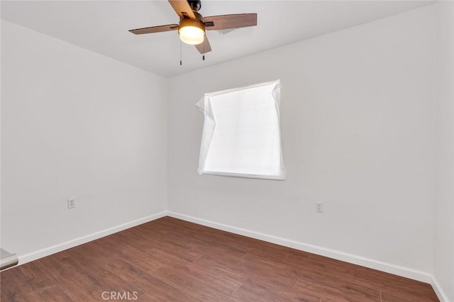 spare room with a ceiling fan, baseboards, and wood finished floors