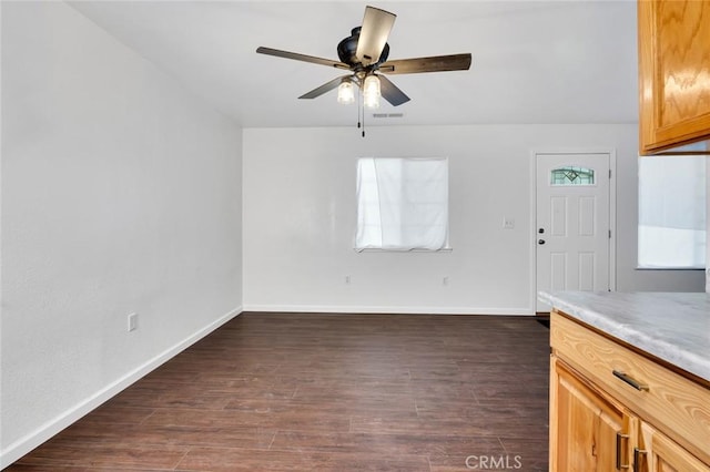 interior space featuring visible vents, baseboards, dark wood finished floors, and a ceiling fan