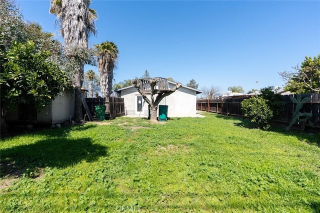 view of yard featuring an outbuilding and a fenced backyard