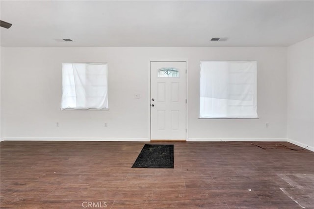 foyer entrance featuring a wealth of natural light, visible vents, and wood finished floors