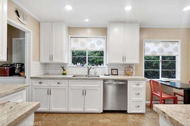 kitchen with dishwasher, crown molding, backsplash, and a sink