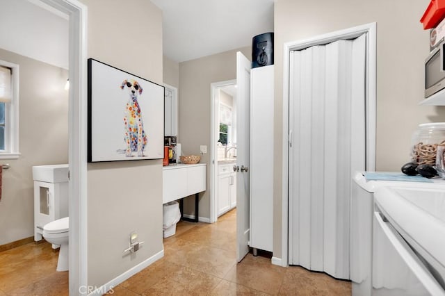 interior space with independent washer and dryer and baseboards