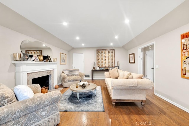 living room with visible vents, wood finished floors, recessed lighting, a fireplace, and baseboards