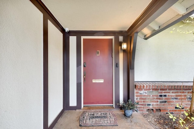 entrance to property featuring stucco siding