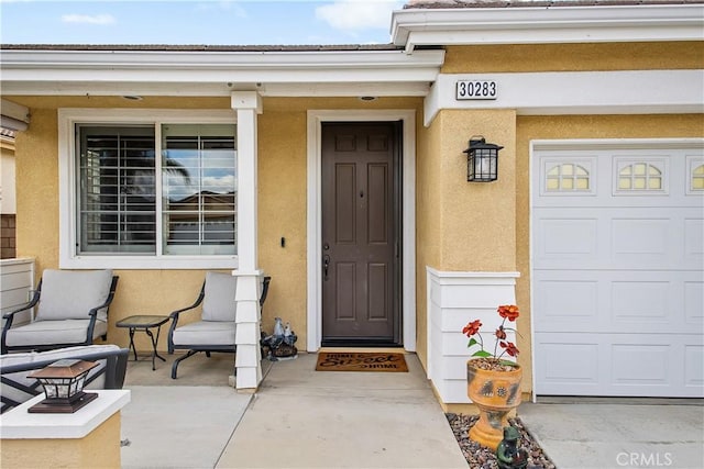 property entrance featuring stucco siding