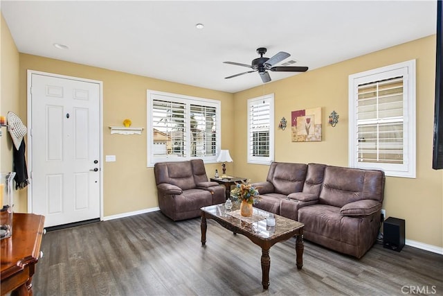 living room with baseboards, wood finished floors, and ceiling fan