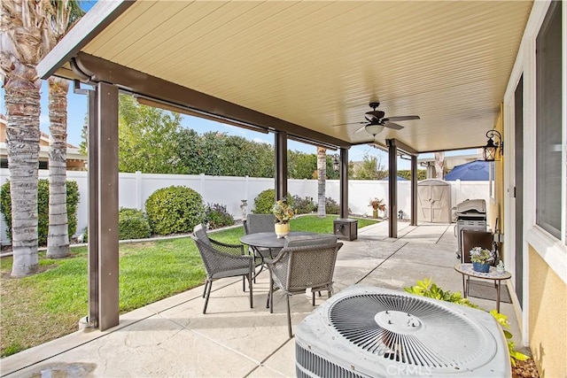 30283 Moon Star Cir, Menifee, CA 92584 - fenced backyard featuring outdoor dining area, a patio area, a ceiling fan, area for grilling, and a storage shed