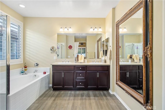 30283 Moon Star Cir, Menifee, CA 92584 - full bathroom with wood finished floors, double vanity, and a garden tub