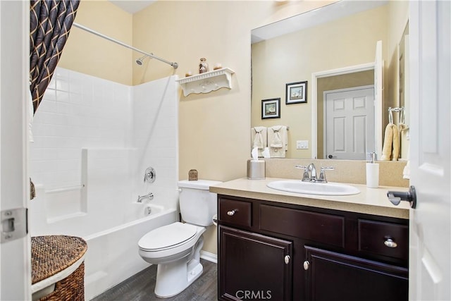 bathroom with shower / bath combo, toilet, vanity, and wood finished floors