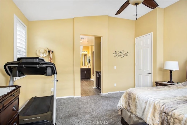carpeted bedroom with baseboards and connected bathroom