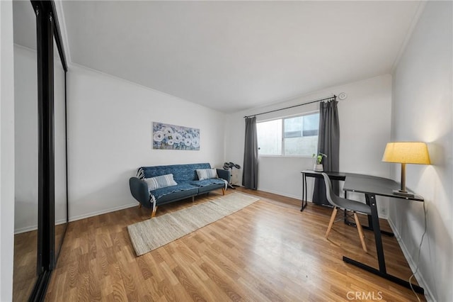 interior space featuring crown molding, baseboards, and wood finished floors