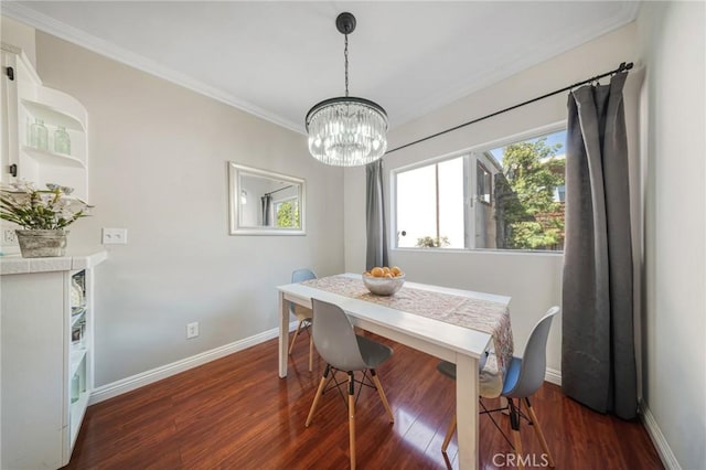 dining area featuring crown molding, wood finished floors, and baseboards