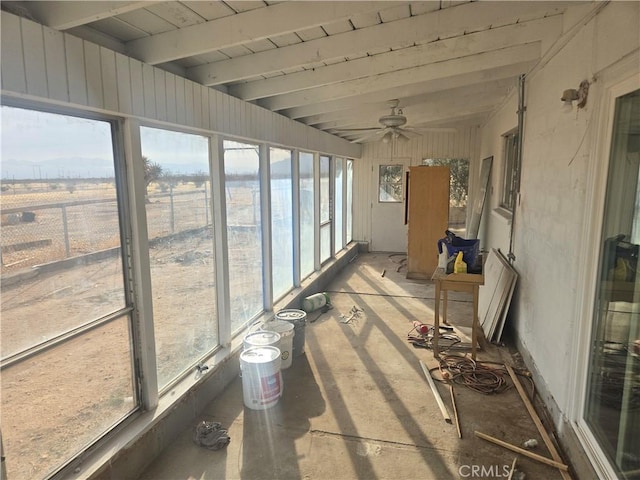 sunroom / solarium featuring beam ceiling