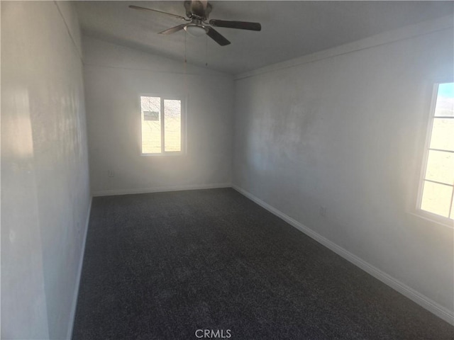 empty room with baseboards, a ceiling fan, lofted ceiling, and carpet