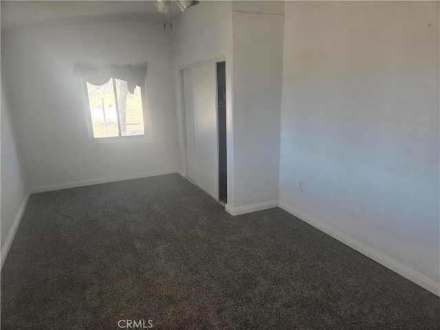 spare room with baseboards and carpet floors