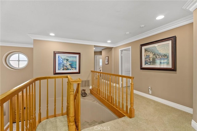 hall with an upstairs landing, ornamental molding, recessed lighting, carpet, and baseboards