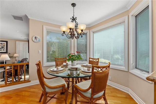 dining area with a chandelier, visible vents, baseboards, and light wood-style floors