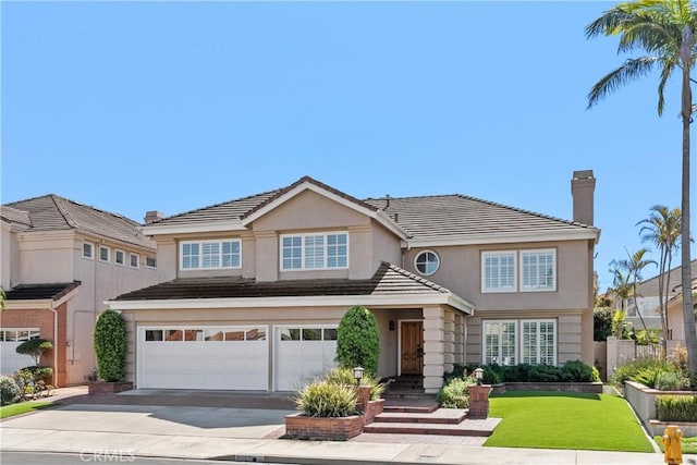 traditional home with stucco siding, driveway, a tile roof, an attached garage, and a chimney