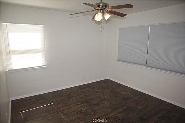 unfurnished room with a ceiling fan, wood finished floors, and baseboards