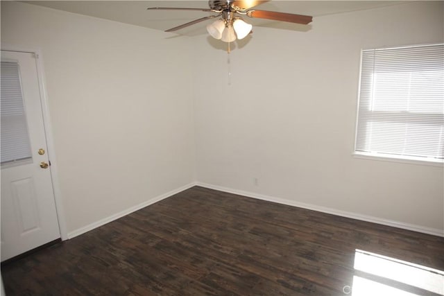 unfurnished room featuring ceiling fan, dark wood-type flooring, and baseboards