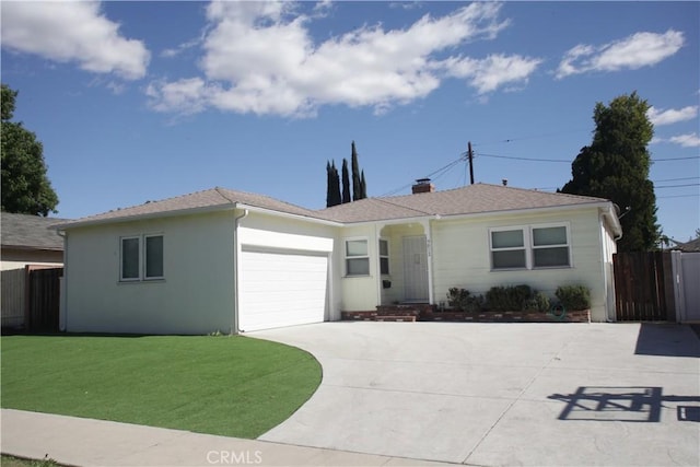 ranch-style house featuring a front yard, an attached garage, fence, and driveway