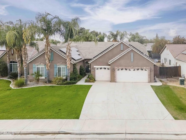 single story home featuring a front yard, an attached garage, fence, and stucco siding