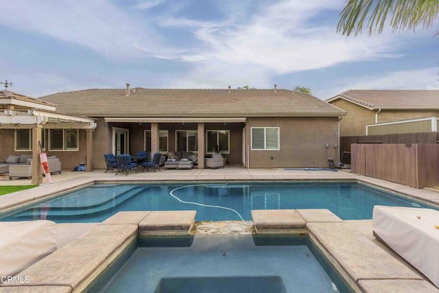 view of pool with a patio area, an outdoor hangout area, a pool with connected hot tub, and fence