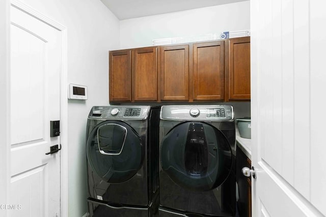 laundry area with cabinet space and independent washer and dryer