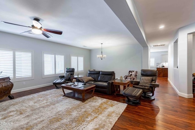 living area with visible vents, baseboards, recessed lighting, ceiling fan with notable chandelier, and wood finished floors