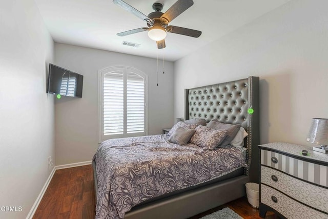 bedroom featuring ceiling fan, visible vents, baseboards, and wood finished floors