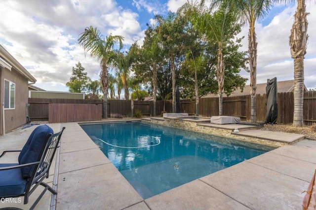 view of swimming pool with a patio, a fenced backyard, and a fenced in pool