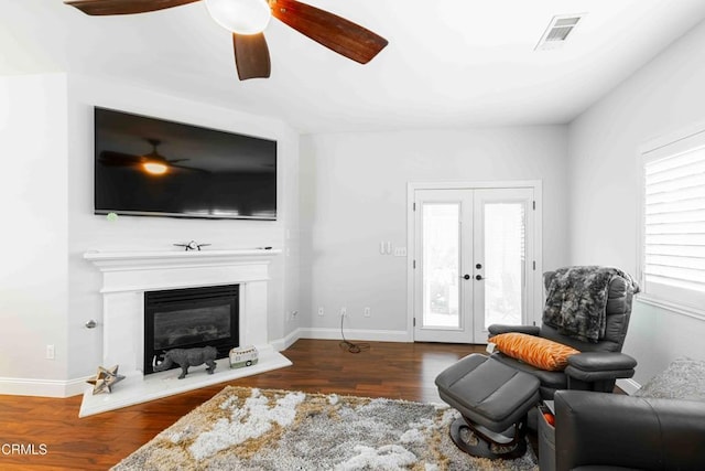 living room with wood finished floors, plenty of natural light, french doors, and visible vents