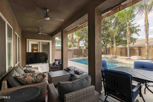 view of patio / terrace featuring a ceiling fan, a fenced backyard, a fenced in pool, and an outdoor hangout area