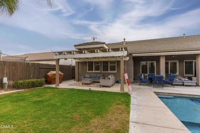 rear view of property featuring a fenced in pool, fence, outdoor lounge area, a patio area, and a lawn