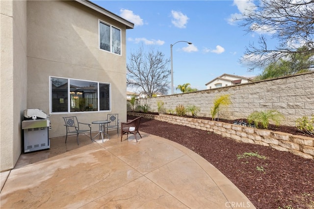 view of patio with a fenced backyard and a grill