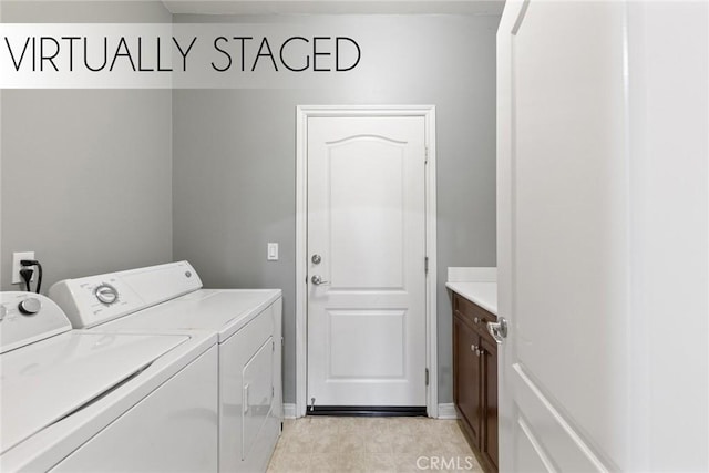 clothes washing area featuring cabinet space and washer and dryer