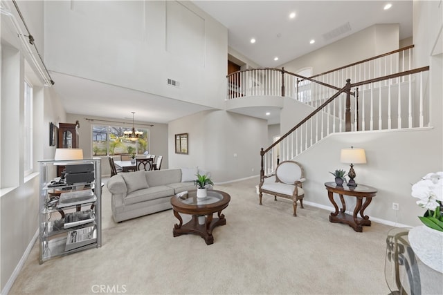 living area featuring visible vents, stairway, a high ceiling, carpet flooring, and baseboards