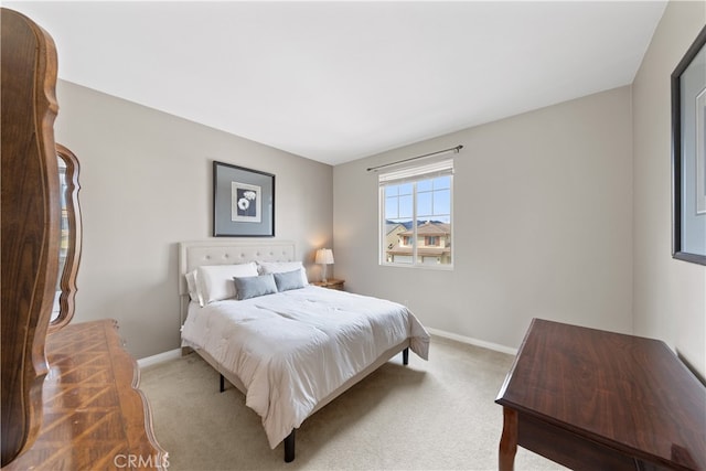 carpeted bedroom featuring baseboards