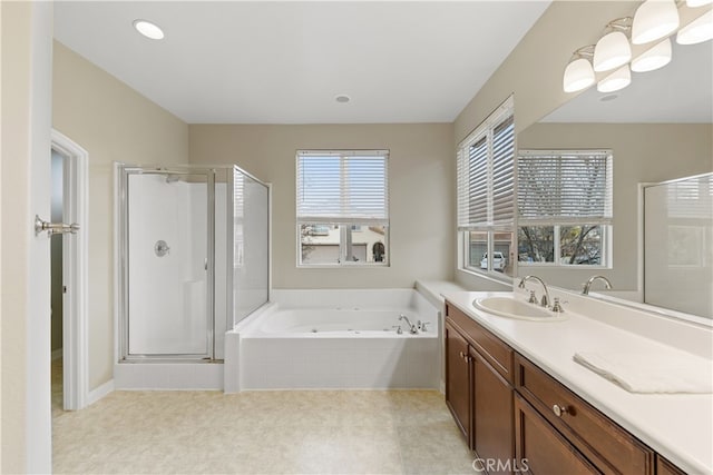 full bath with vanity, a shower stall, and a garden tub